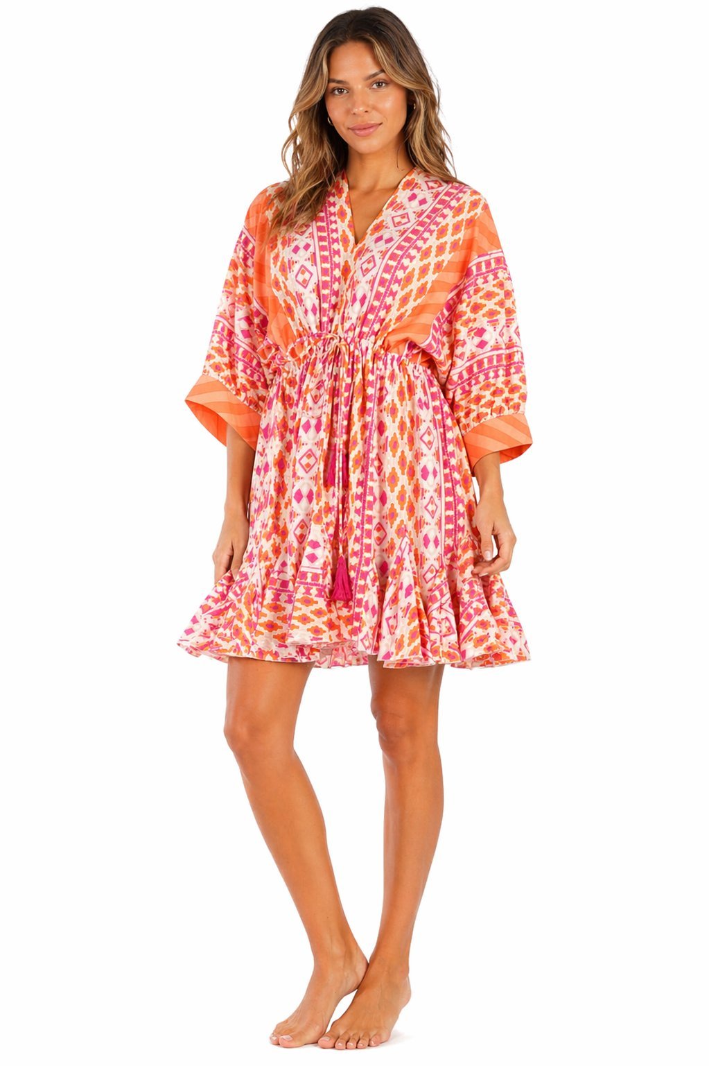 Coral sunset ikat gradient print tiered babydoll mini dress — side detail | Shop boho resort dresses at Club Moda