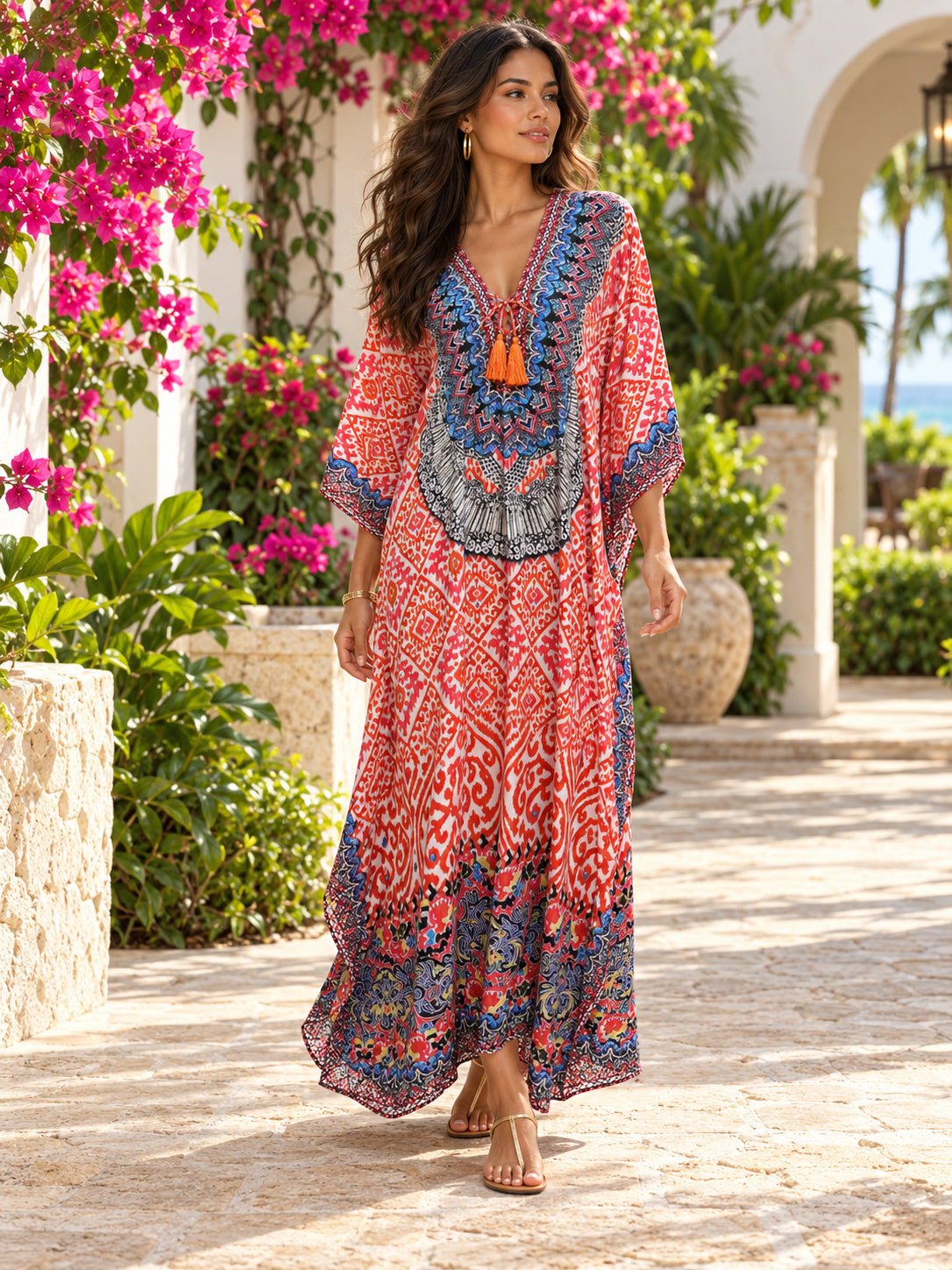 Coral ikat maxi caftan with ornate neckline print worn at a tropical resort