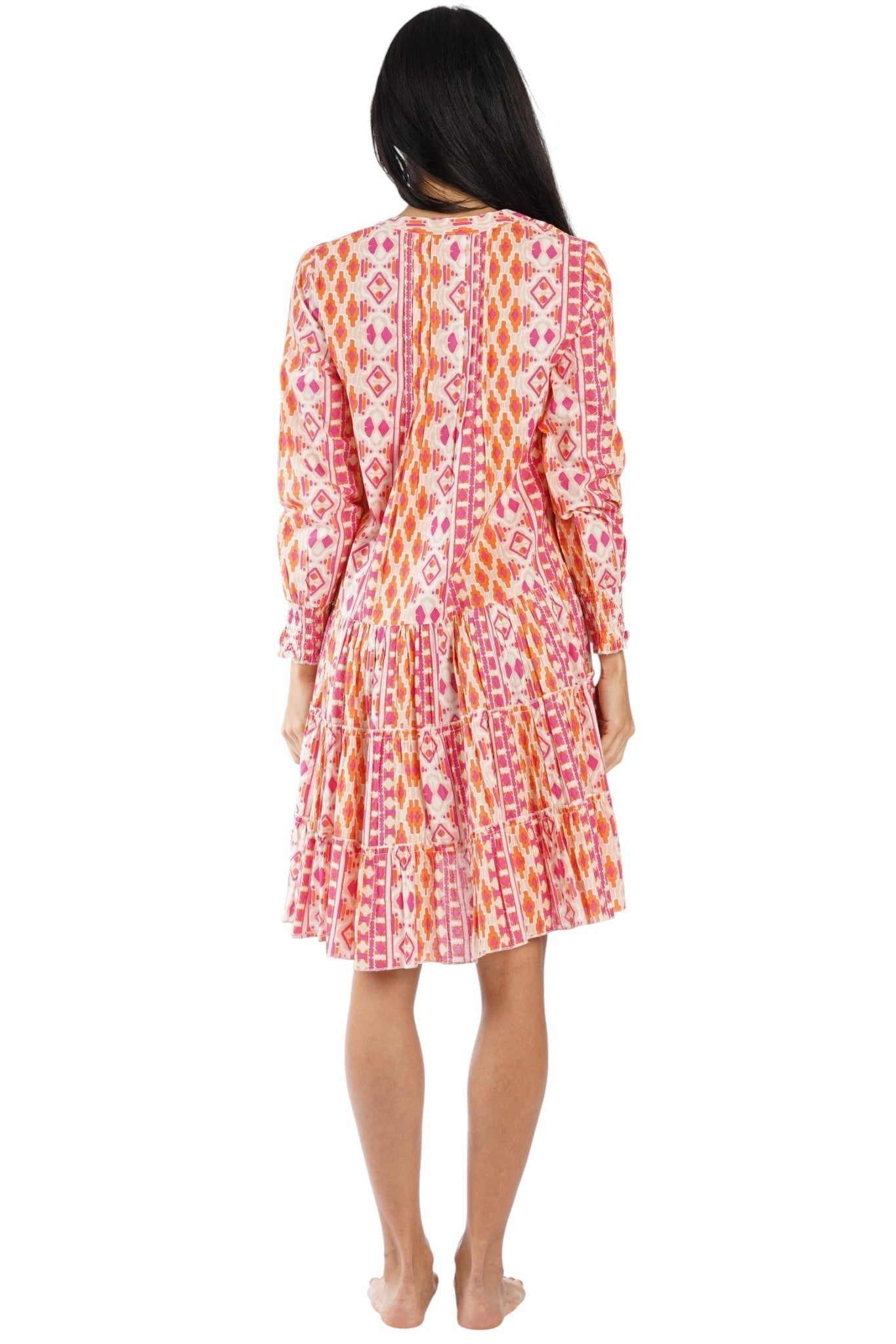 Pink ikat chevron print long-sleeve tiered mini dress — back view | Vacation-ready resort dress